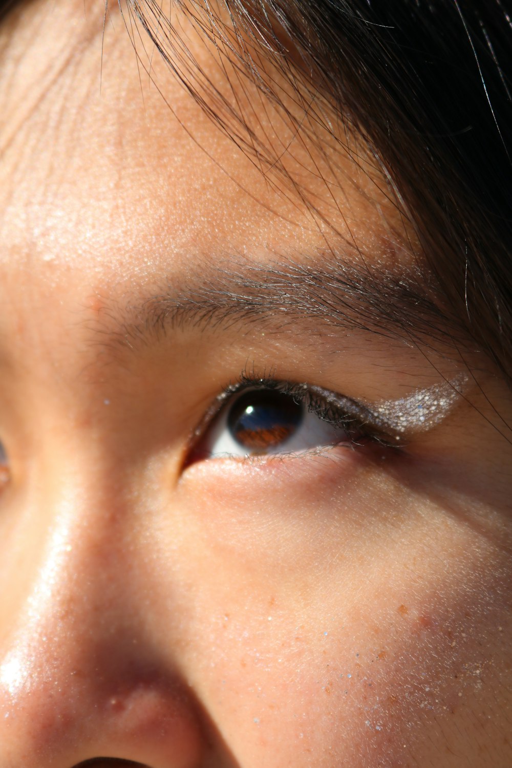 a close up of a person's face with a white eyeliner