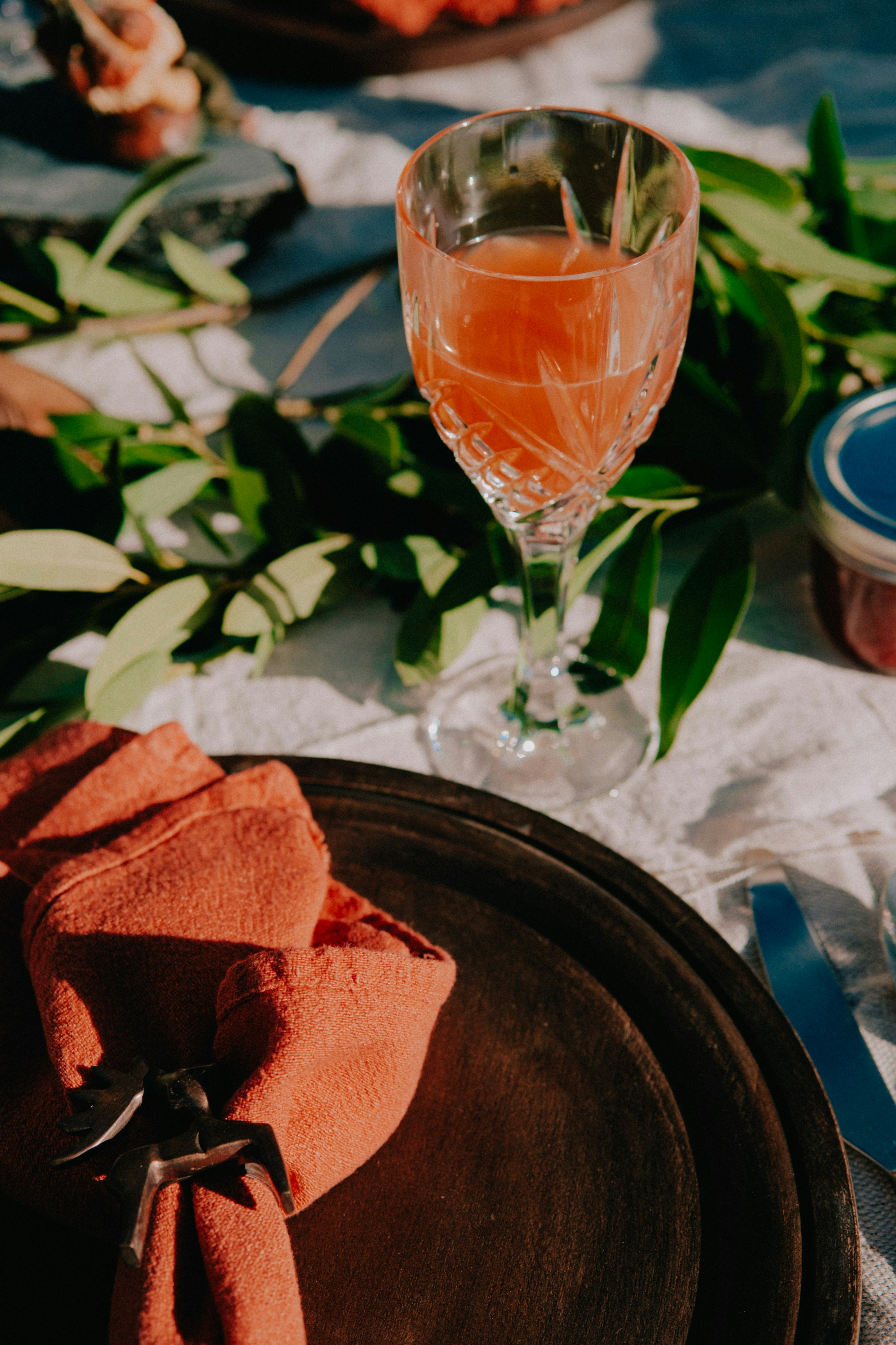 a table topped with a plate of food and a glass of wine