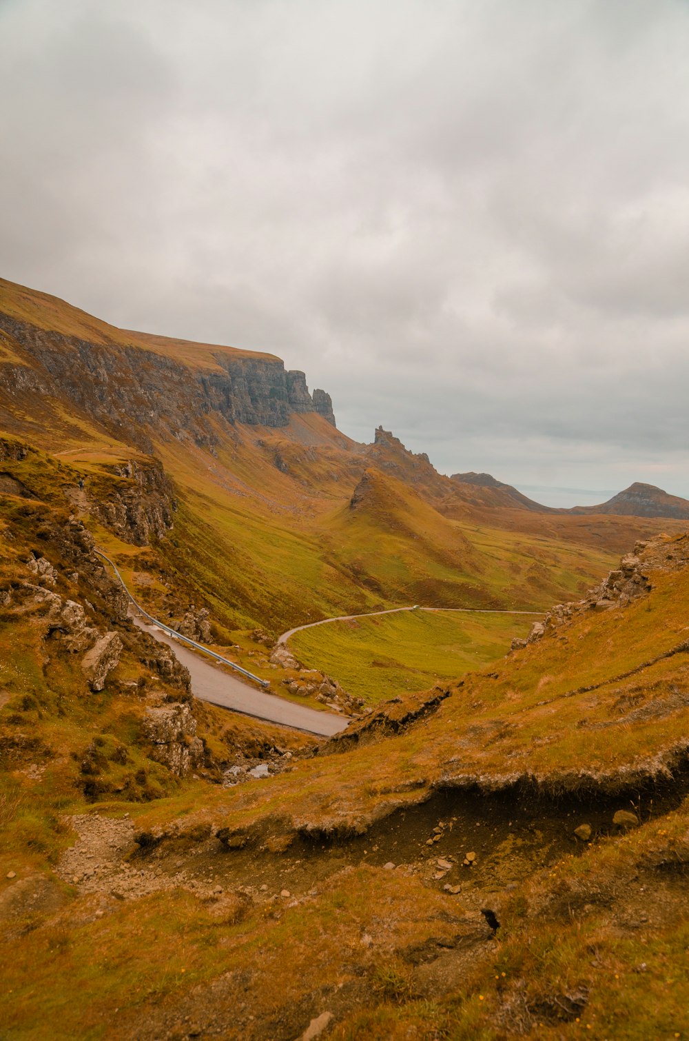 a scenic view of a winding road in the mountains