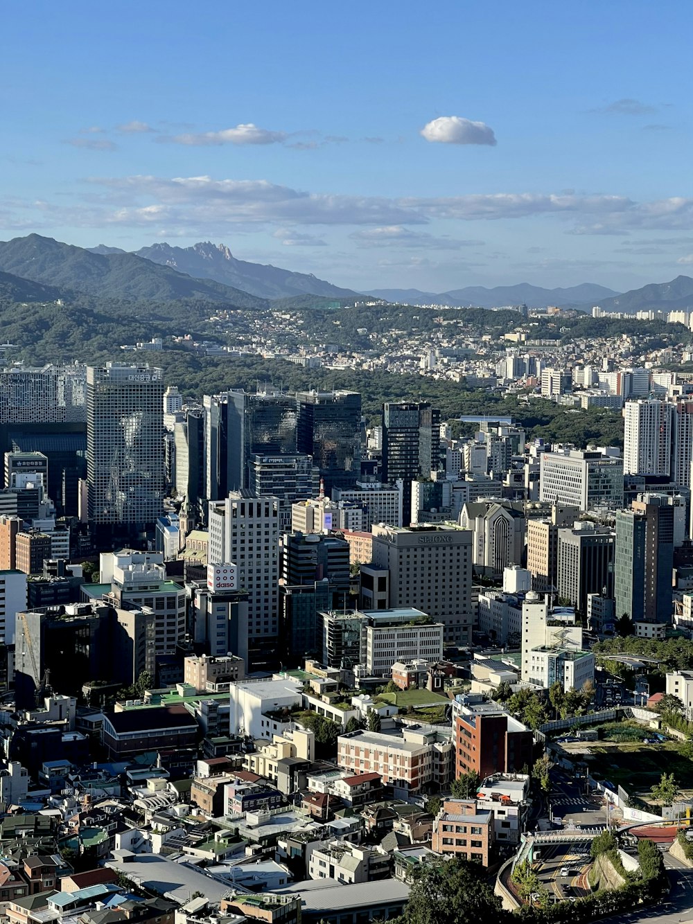 a view of a city with mountains in the background