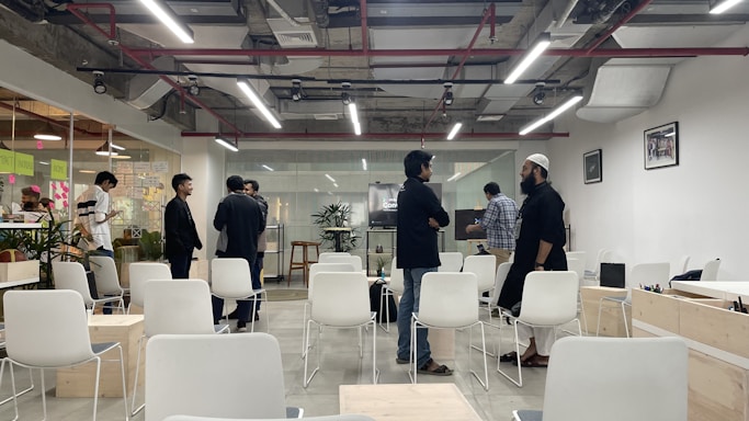 A modern office space with a sleek design and a team discussing investment opportunities.