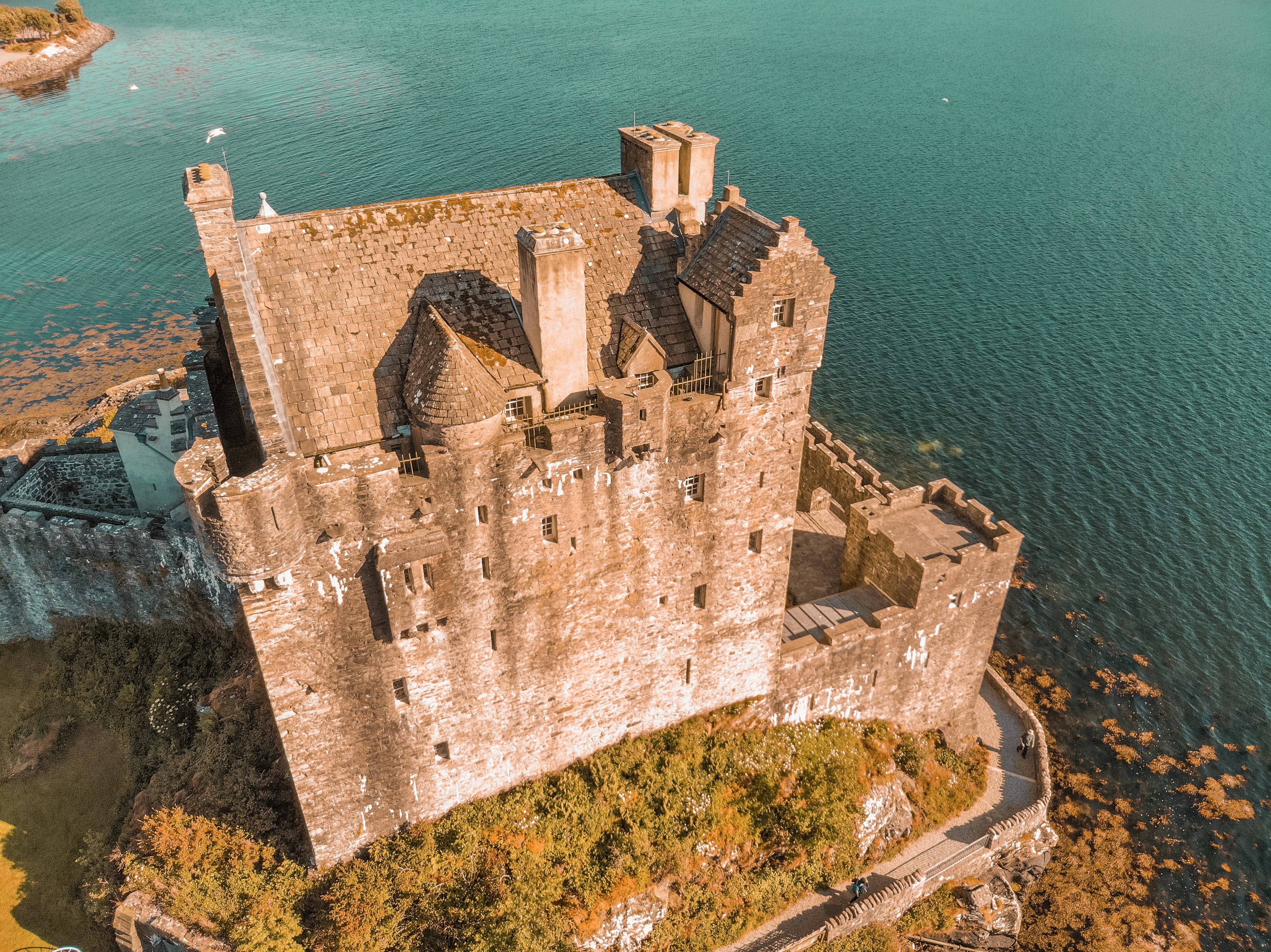 an aerial view of a castle in the middle of a lake, 
