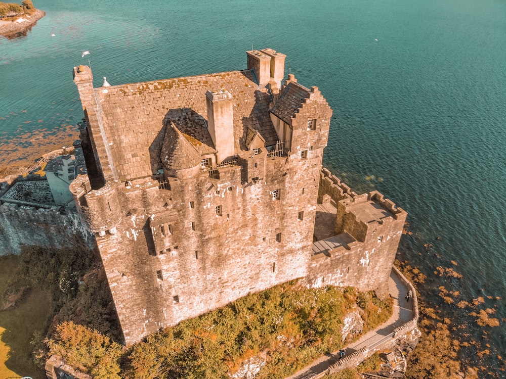 an aerial view of a castle in the middle of a lake