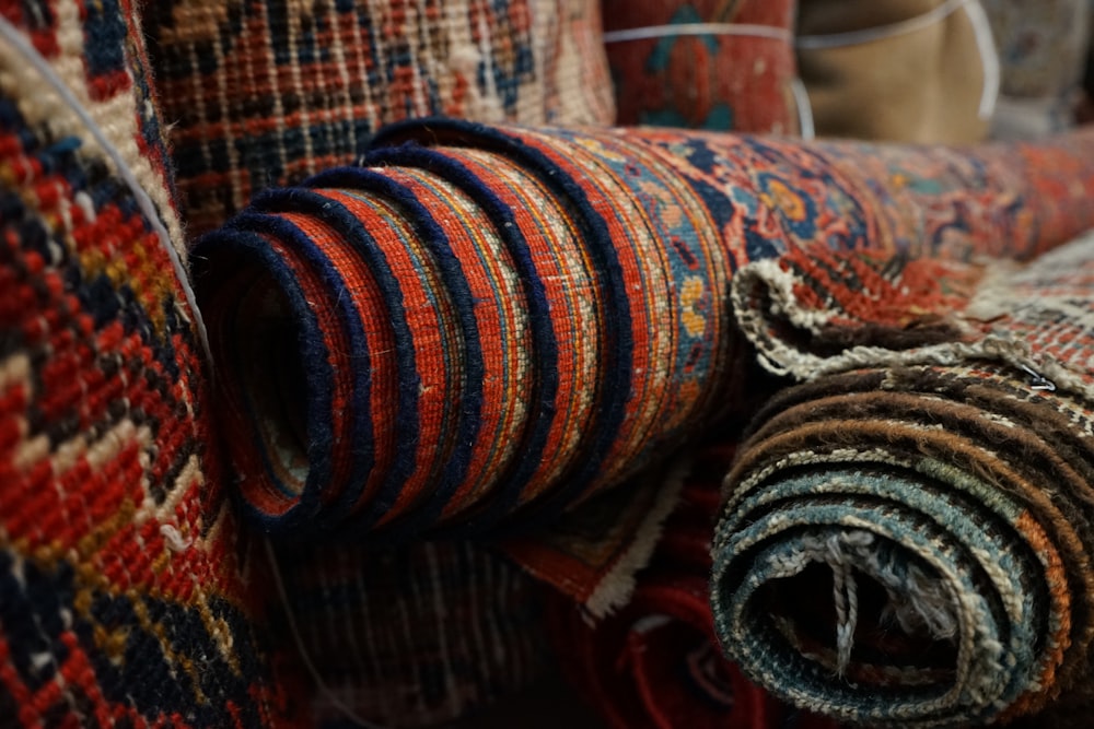 a pile of colorful rugs sitting next to each other