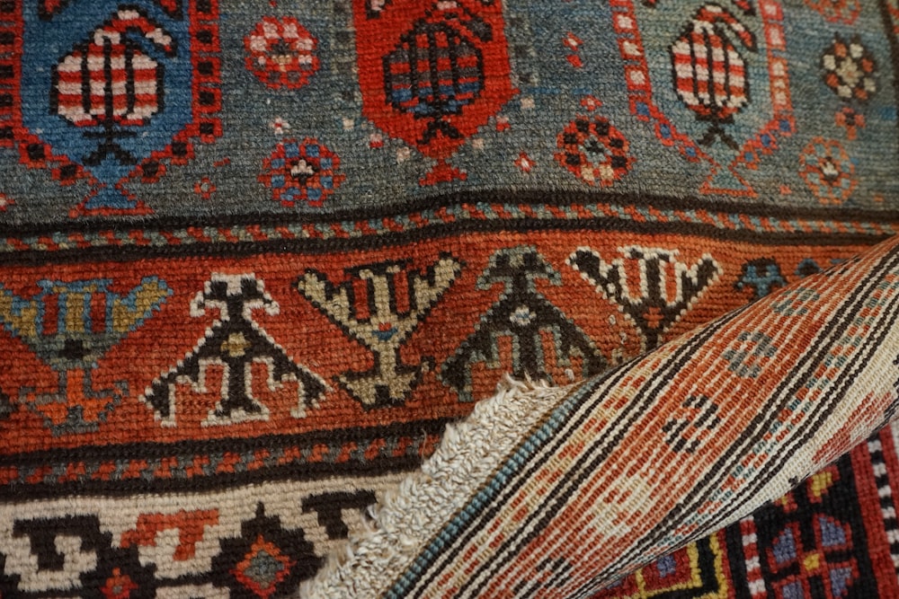 a close up of a colorful rug with many different colors