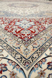 an oriental rug with a red, blue, and white design