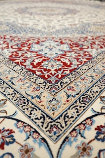an oriental rug with a red, blue, and white design