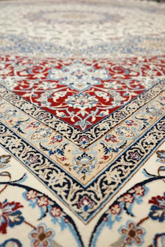 an oriental rug with a red, blue, and white design
