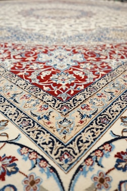 an oriental rug with a red, blue, and white design