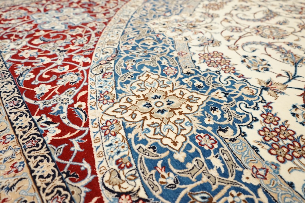a red, white, and blue rug with an intricate design
