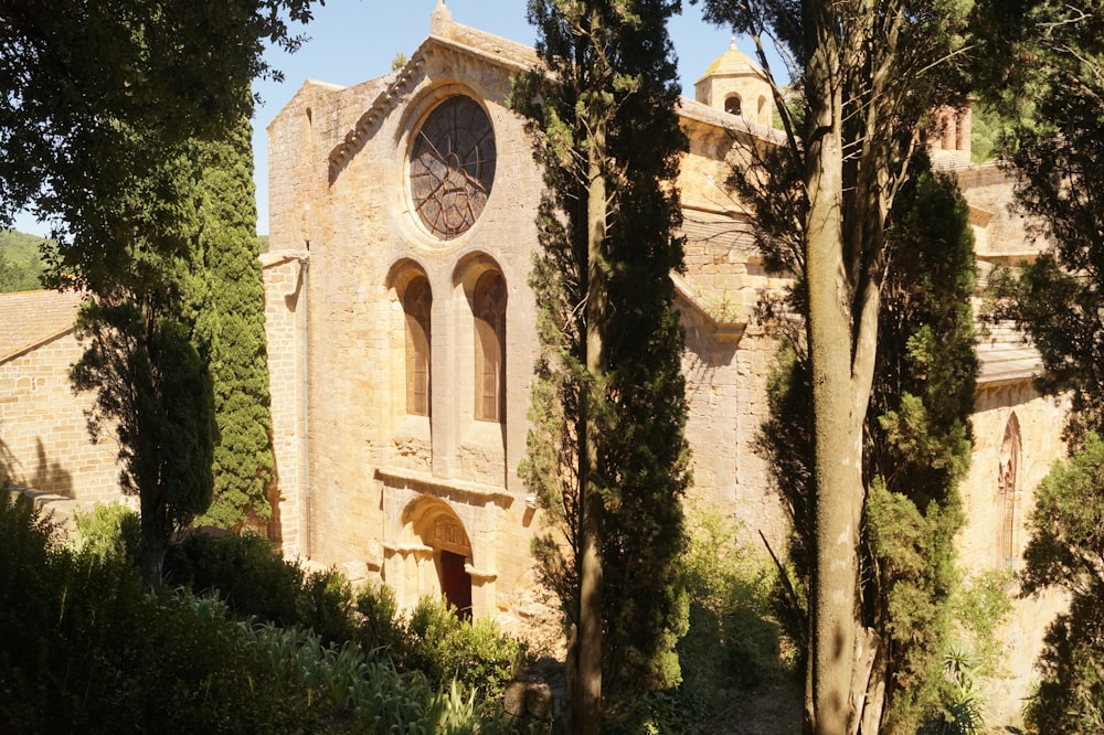 a stone building with a clock on the side of it