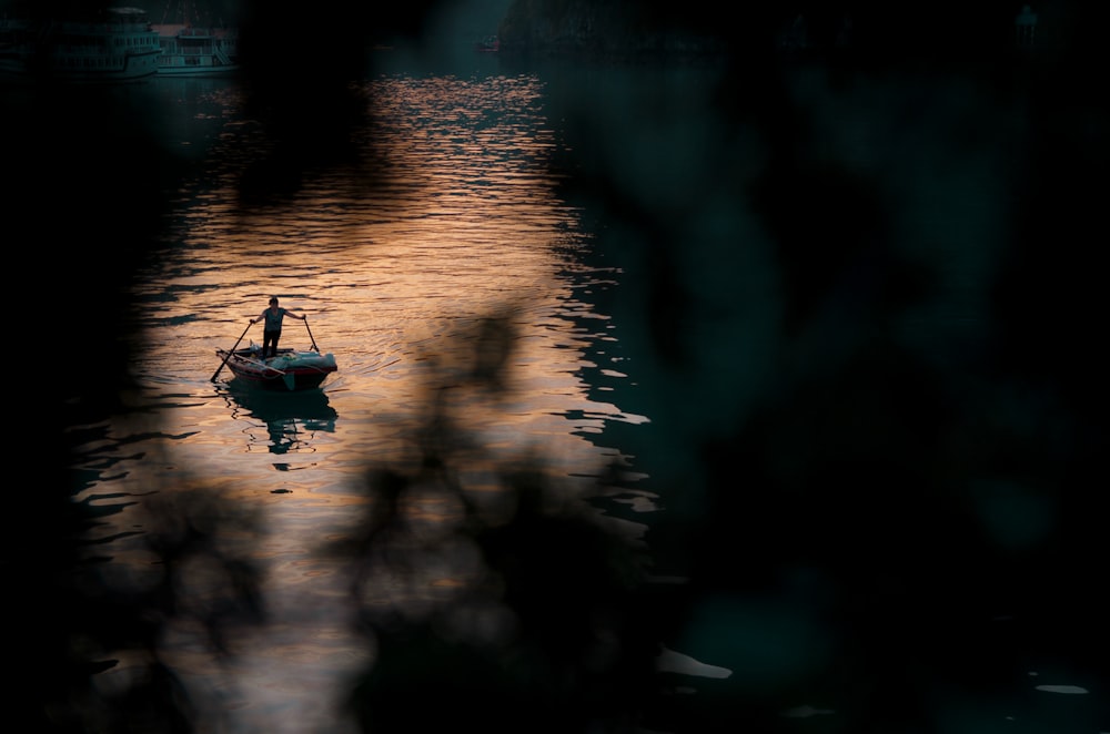 a small boat floating on top of a body of water