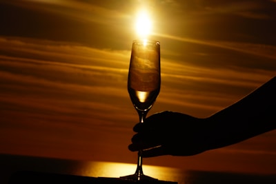Close-up of a chilled champagne glass catching the sunlight on a luxury yacht deck.
