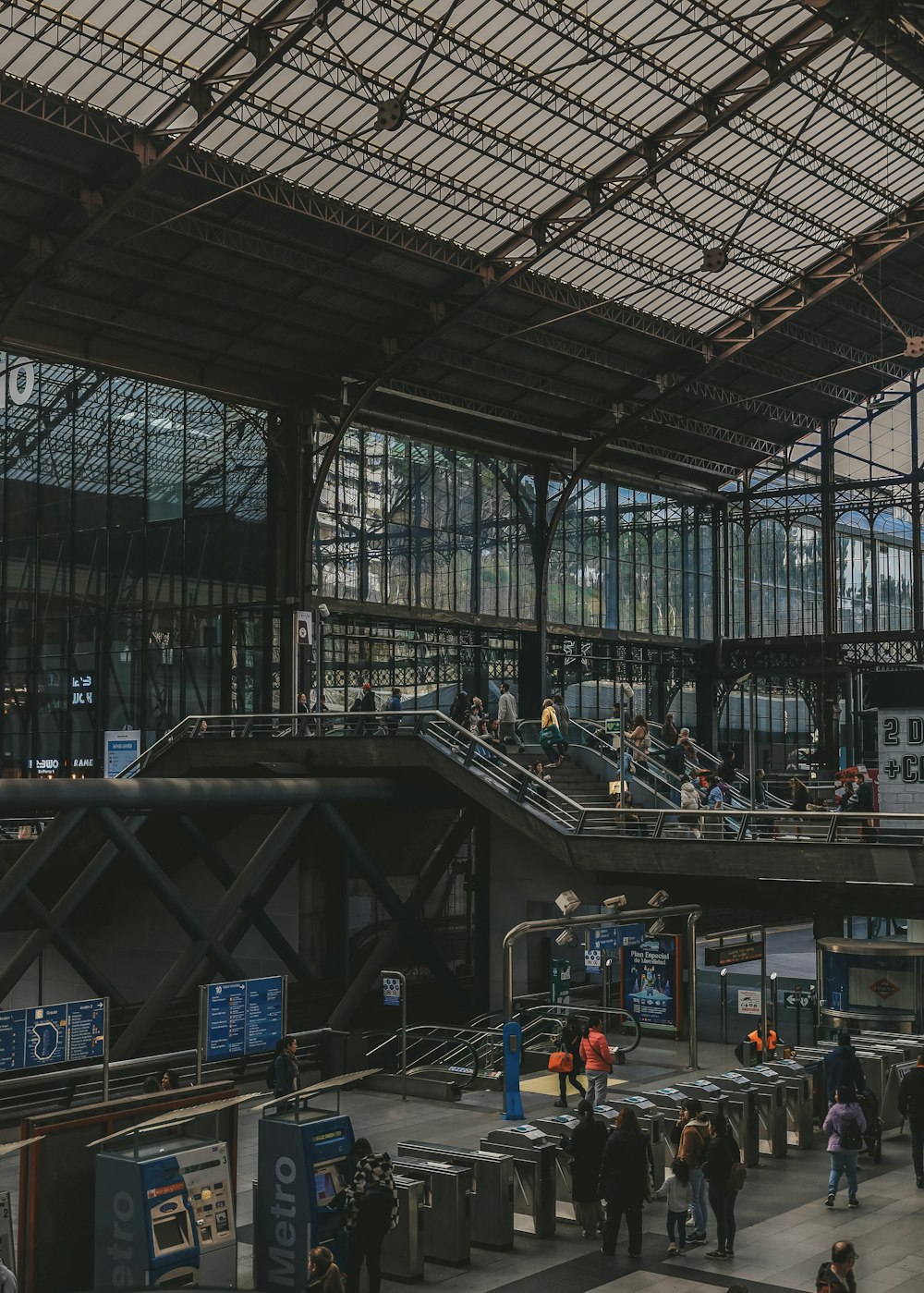 a group of people walking around a train station