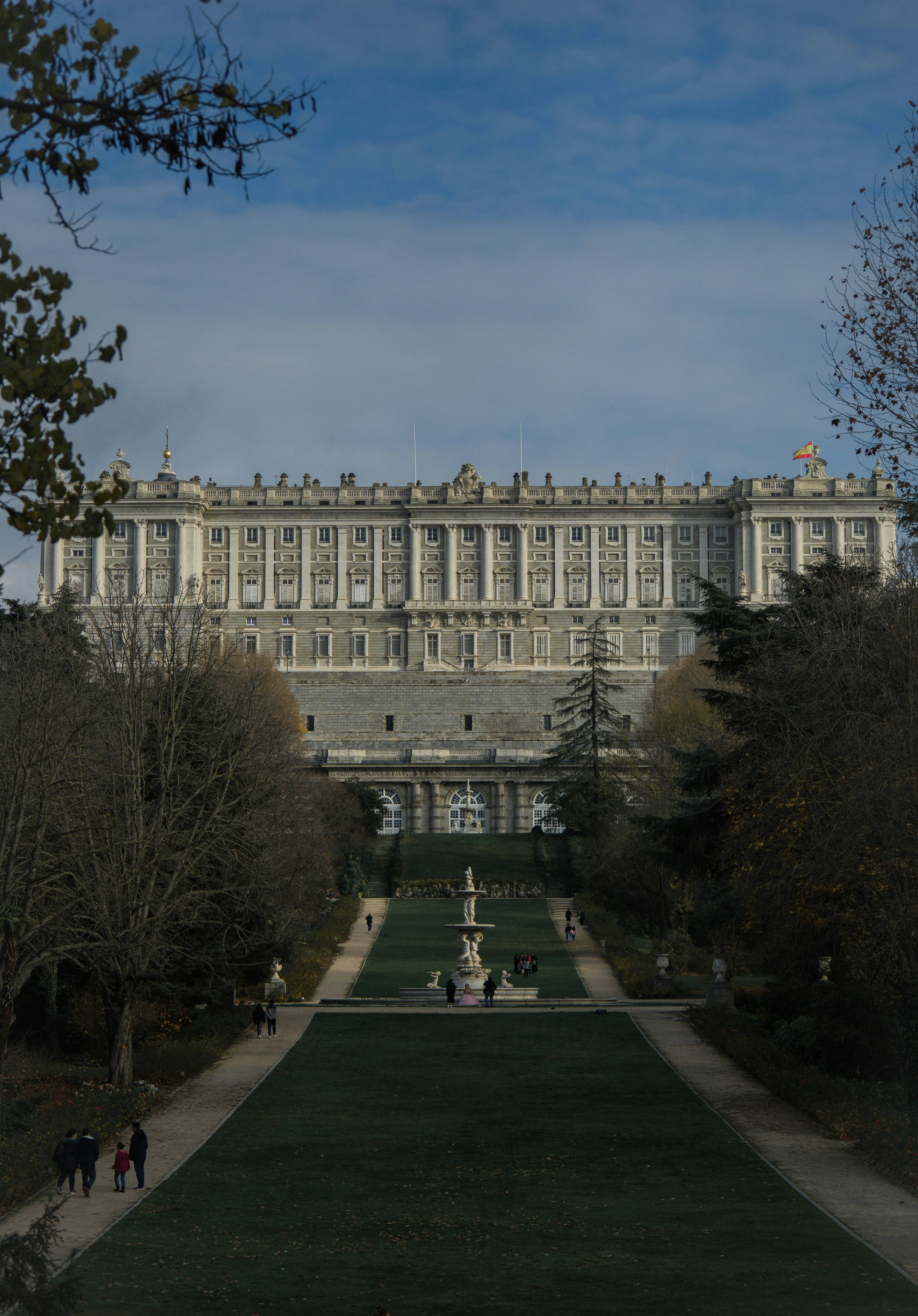 a large building with a long lawn in front of it