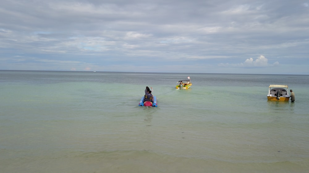 a group of people riding on top of a boat in the ocean