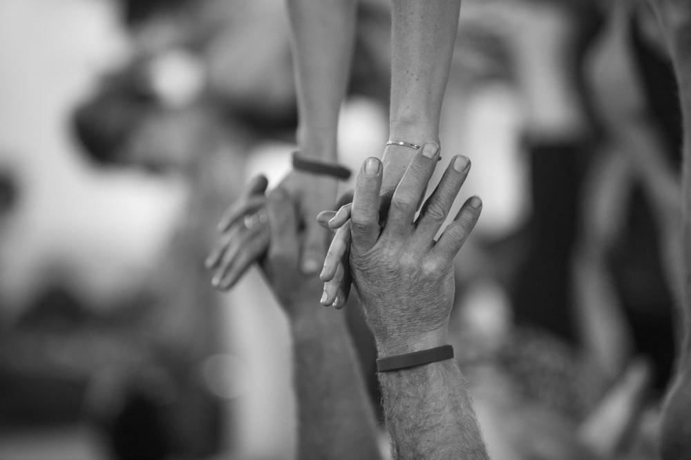 a group of people with their hands together