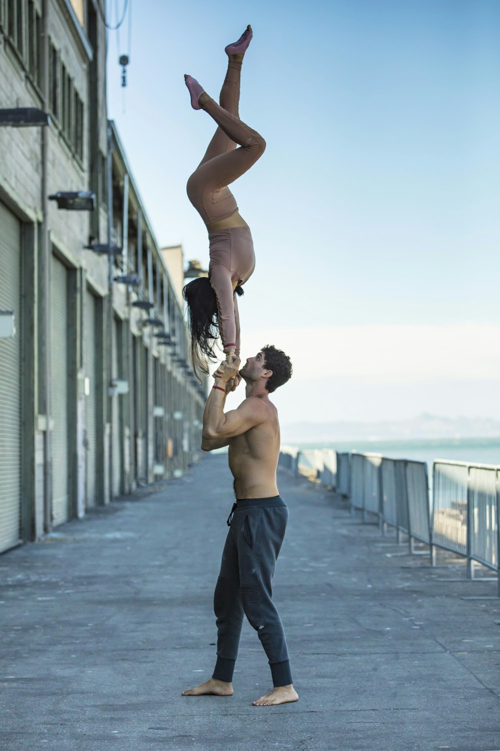 a man and a woman doing acrobatic tricks