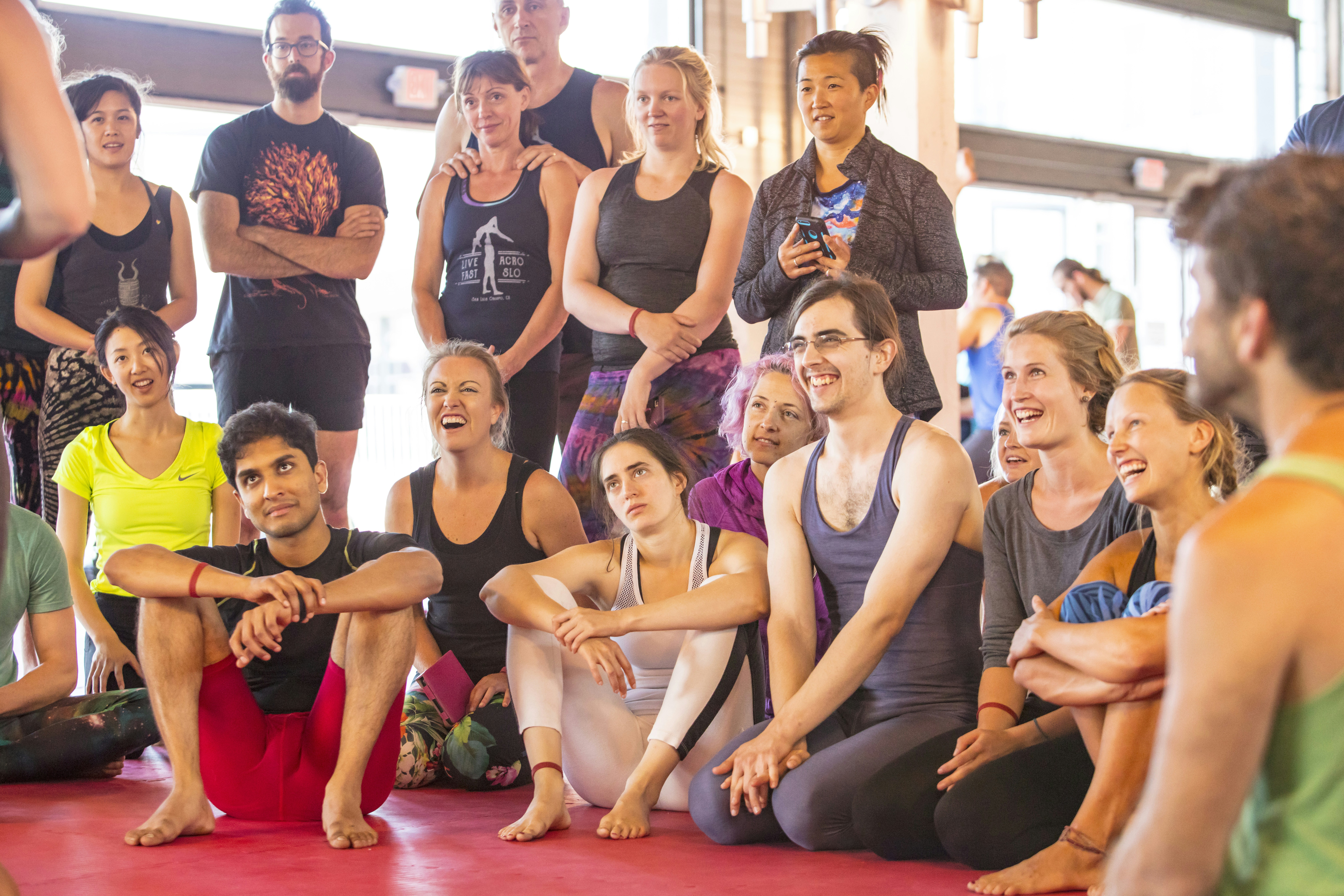 a group of people sitting and standing around each other