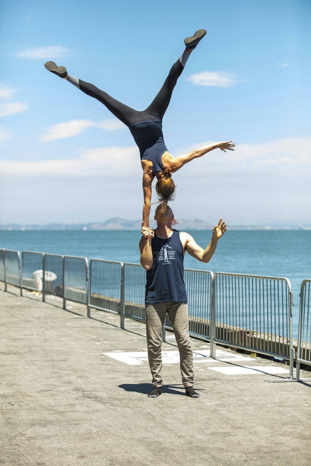 a man doing a handstand on top of a woman