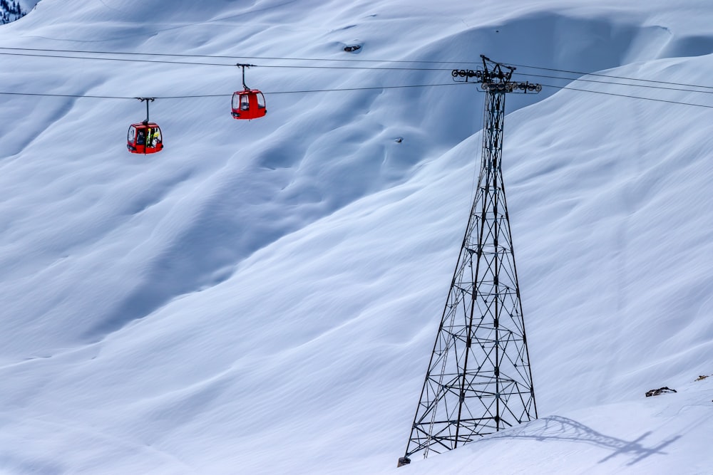 a ski lift going up a snowy mountain