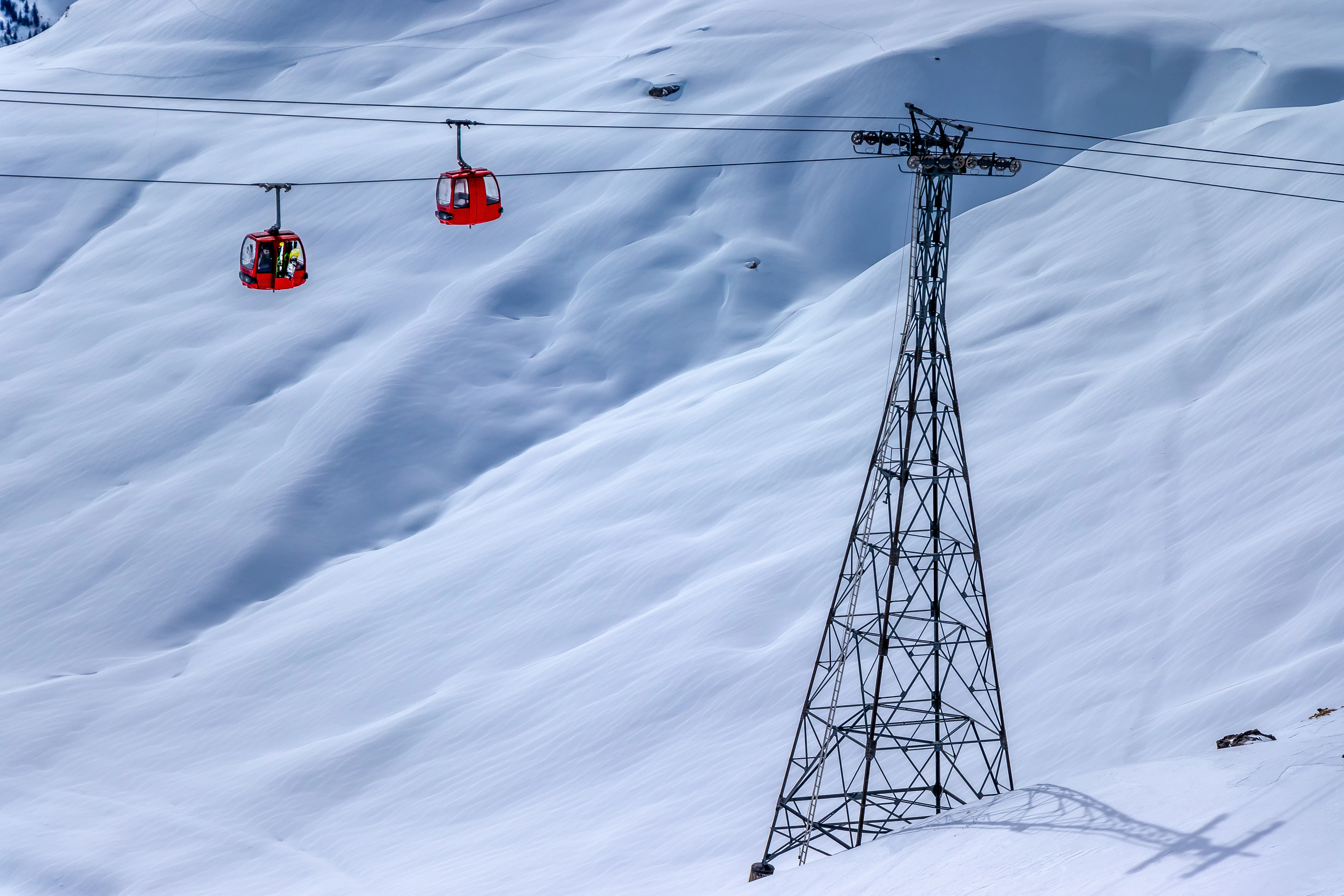 A ski lift climbing a snowy slope in La Plagne