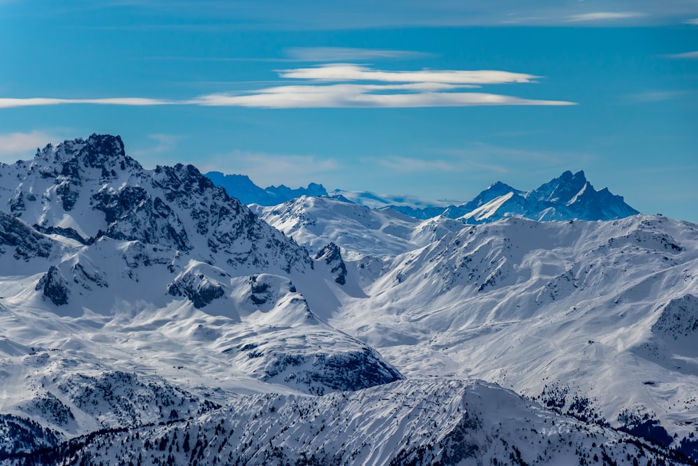 a snowy mountain range under a blue sky