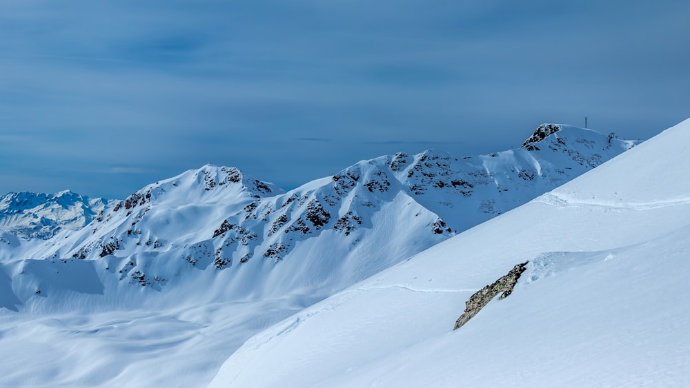 a man riding skis down the side of a snow covered slope