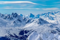 A panoramic view of a snowy peak with a clear horizon.