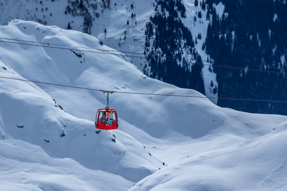 a ski lift going up a snowy mountain