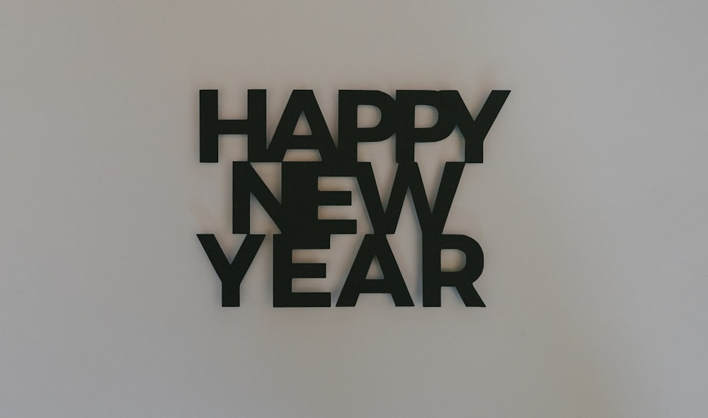 a happy new year cut out of black paper