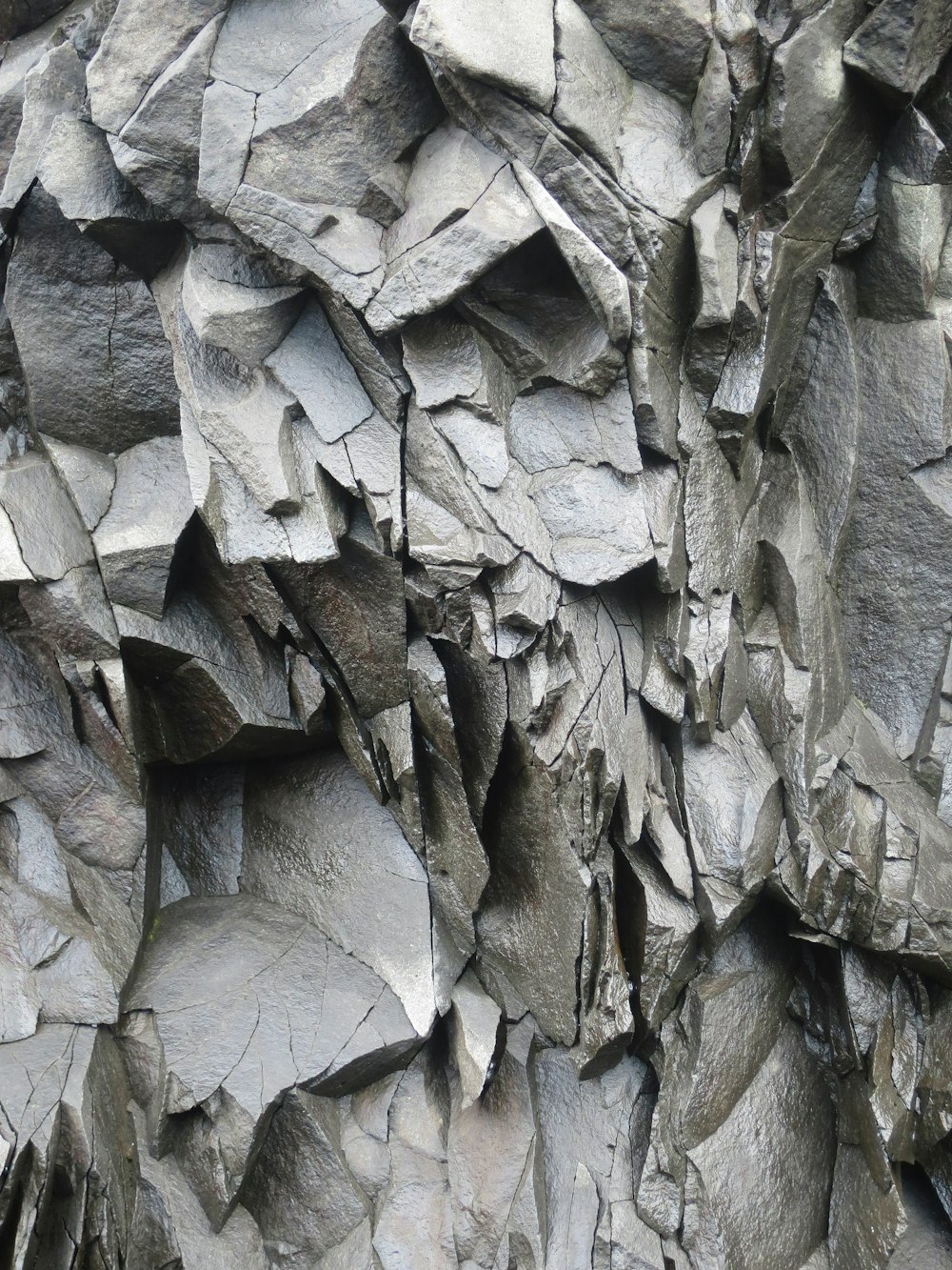 a close up of a rock wall with a clock on it