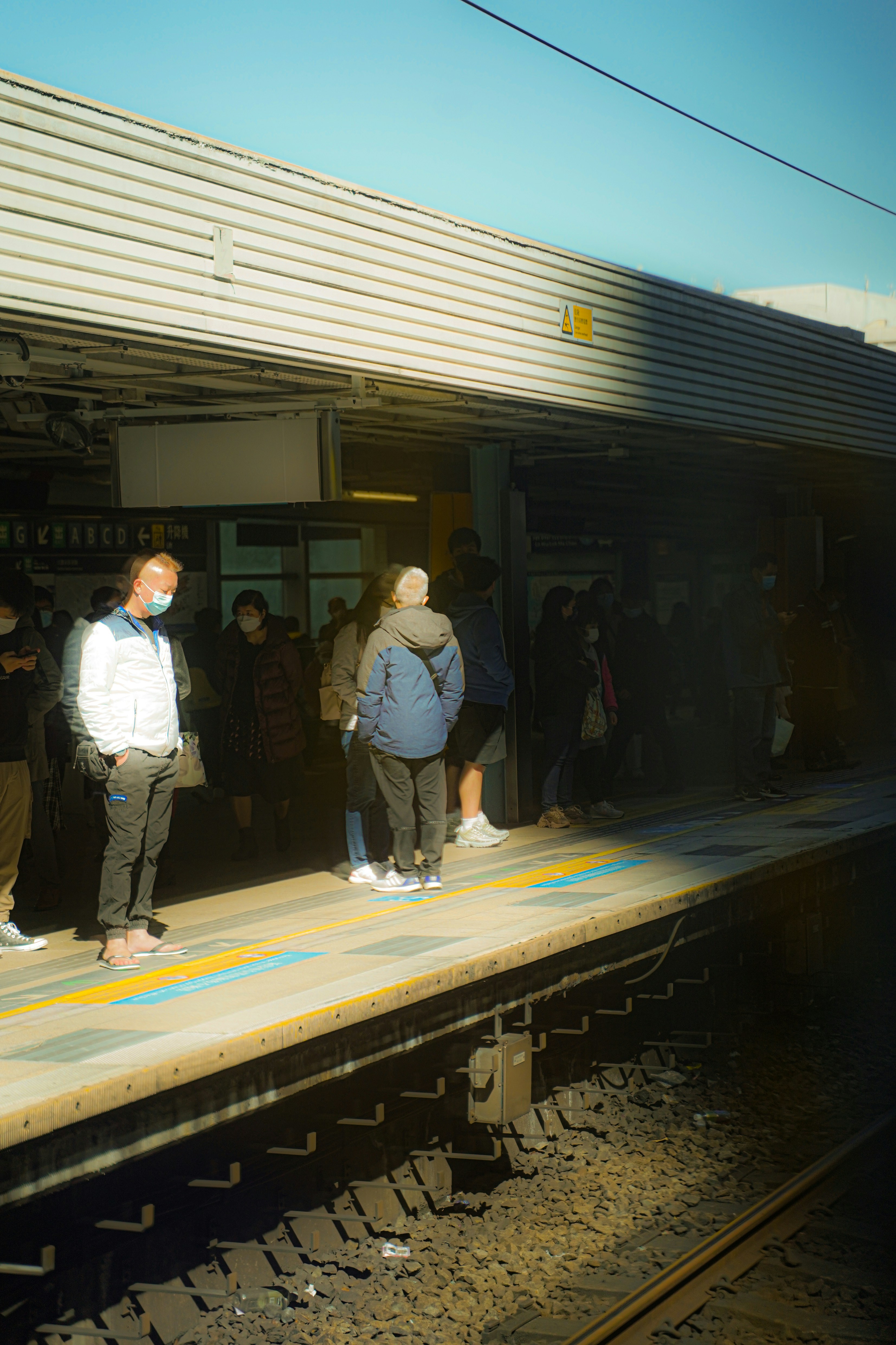 a group of people standing on a train platform