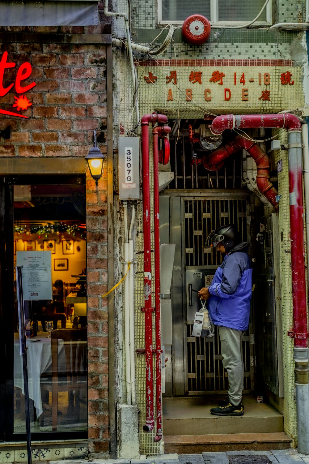 a man standing in a doorway of a restaurant