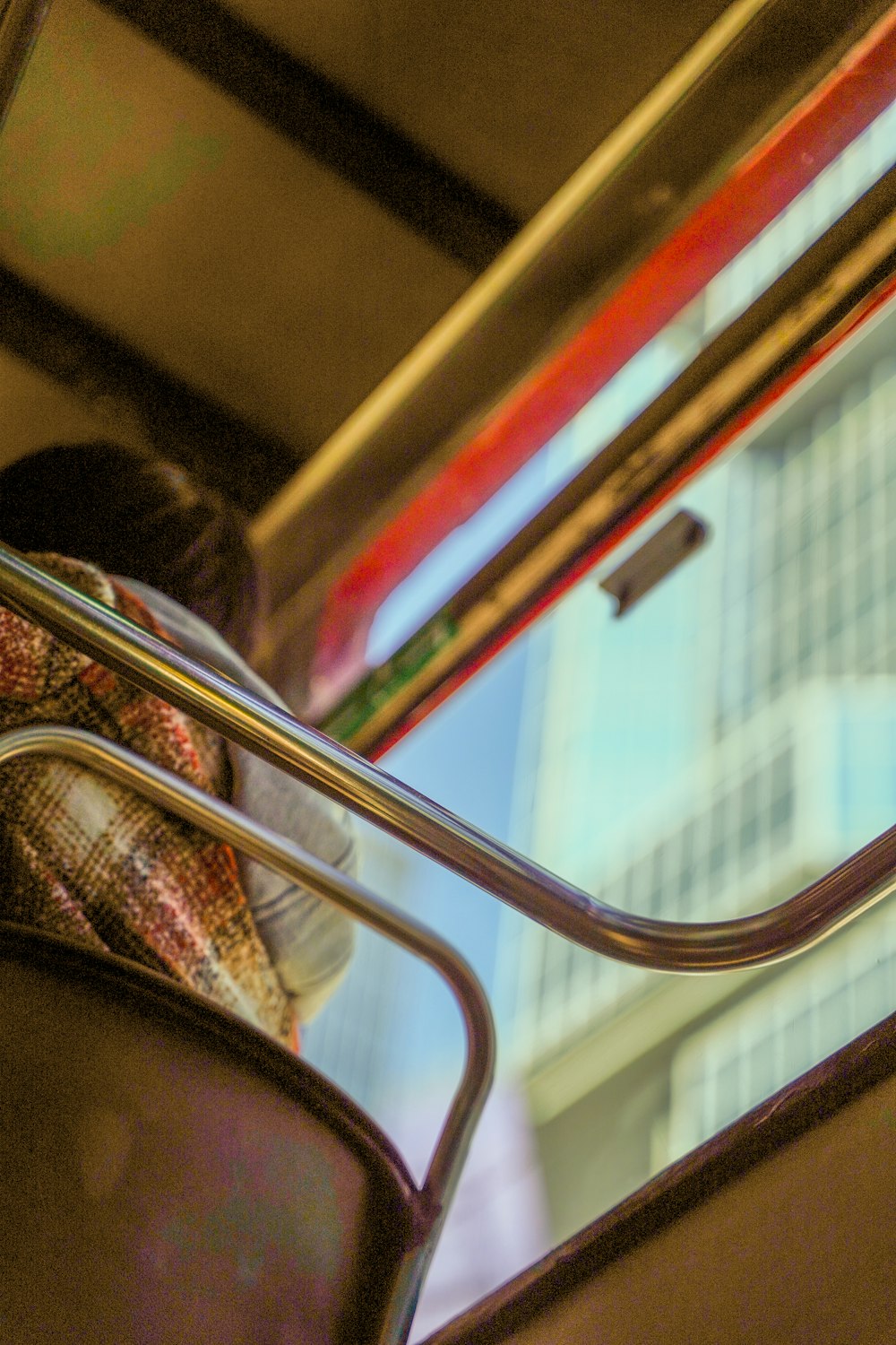 a woman sitting on a bus looking out the window