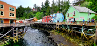 a river running through a small town next to tall buildings