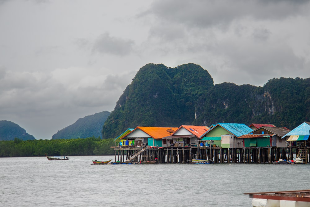 a group of houses sitting on top of a body of water