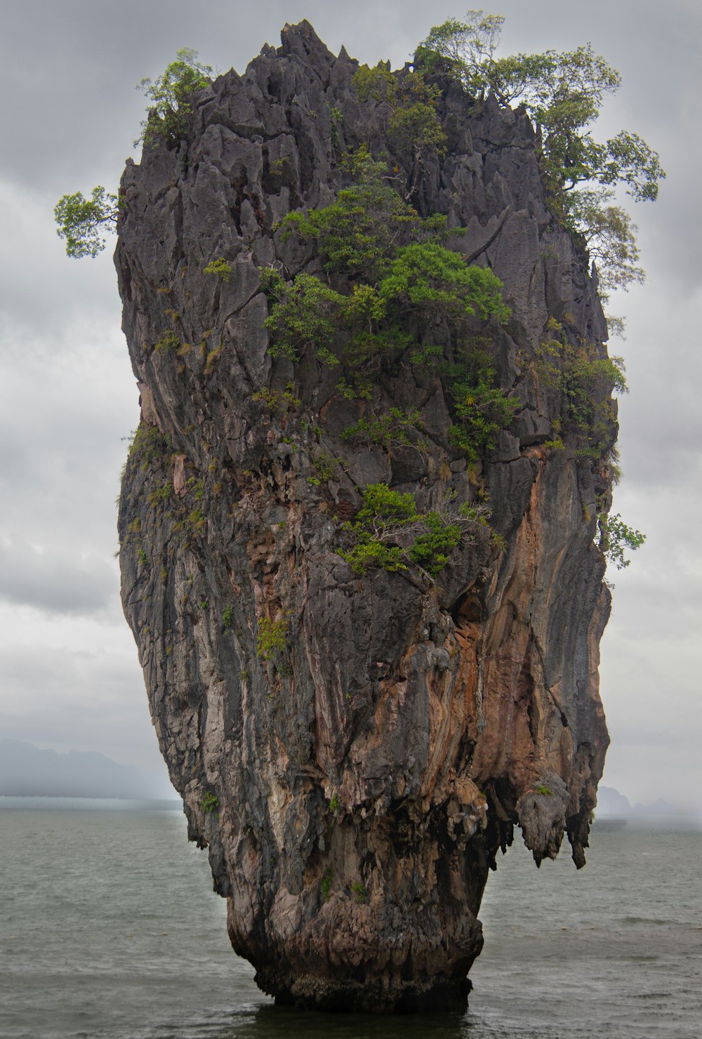 a rock outcropping in the middle of a body of water