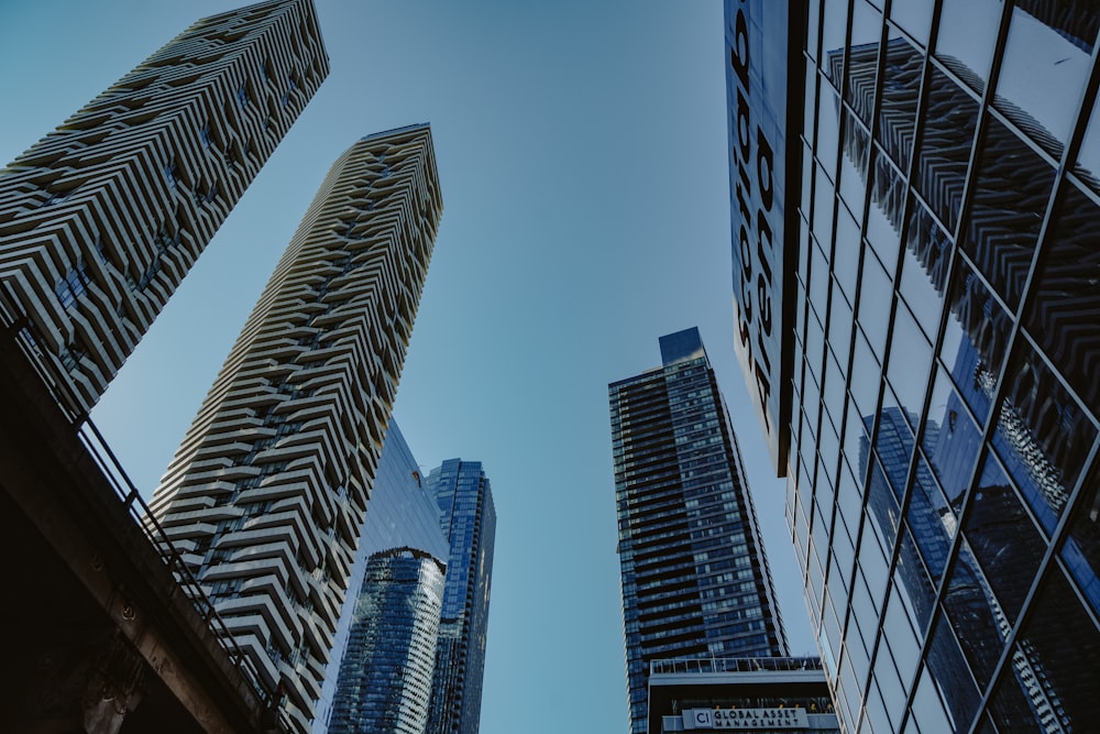 looking up at tall buildings in a city