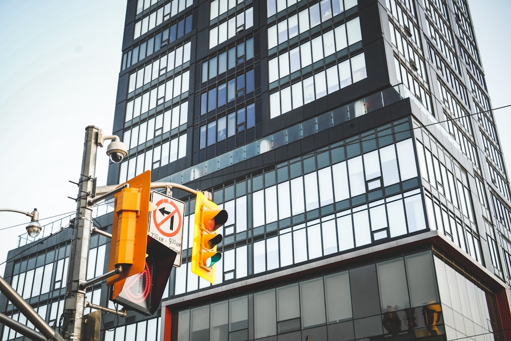 a traffic light in front of a tall building