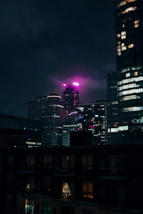 a view of a city at night from a rooftop