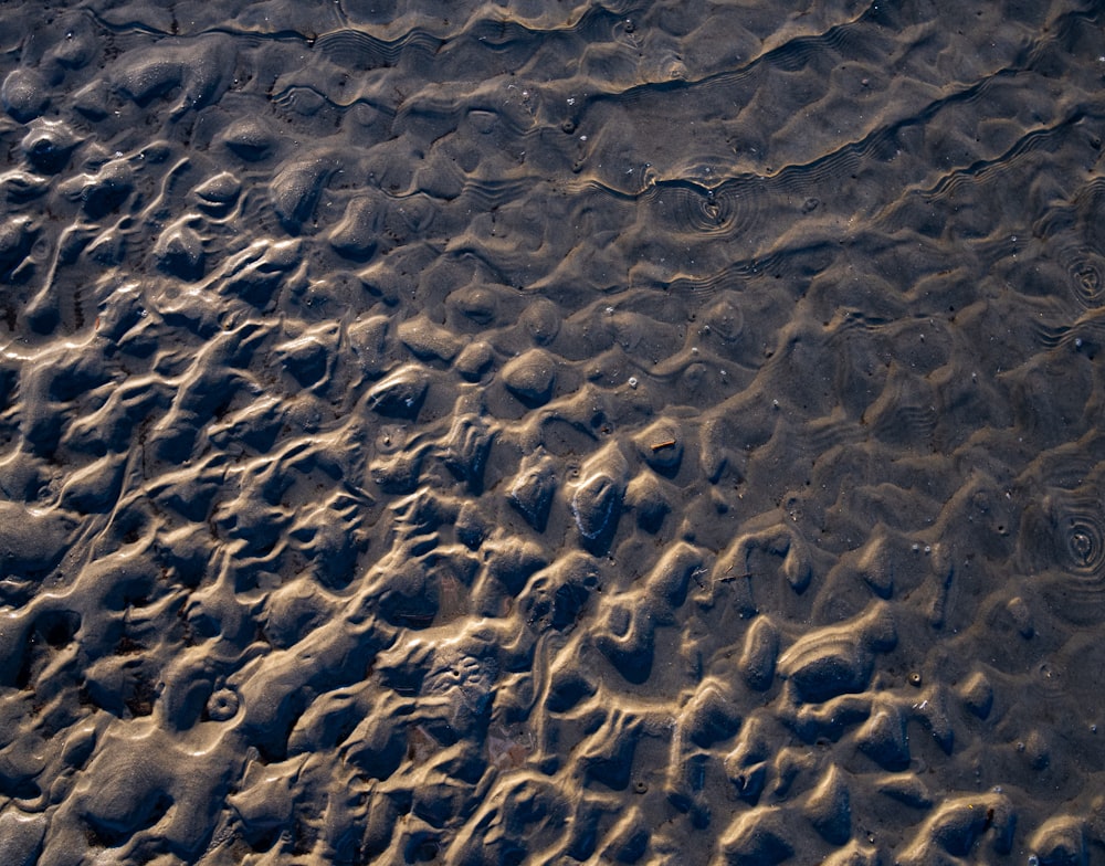 a close up of sand and water on a beach