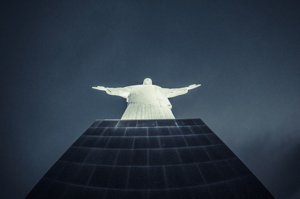 a large statue of jesus on top of a building