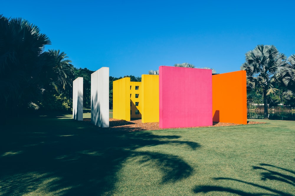 a row of brightly colored structures in a park