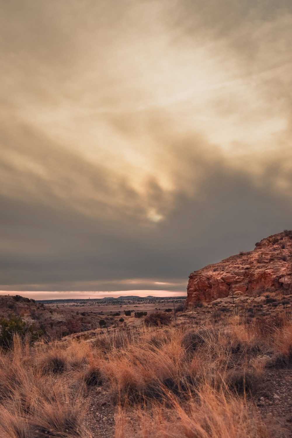 a large rock outcropping in the middle of a desert