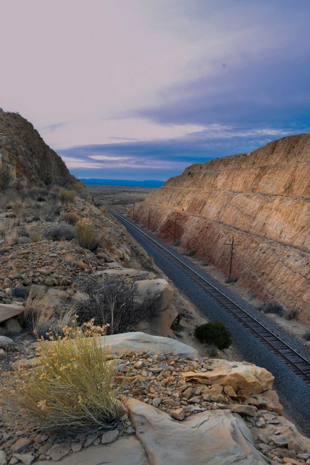 a train track running through a desert landscape