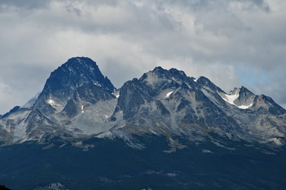 a mountain range with snow capped mountains in the background