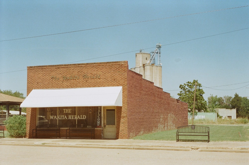 an old brick building with a white awning