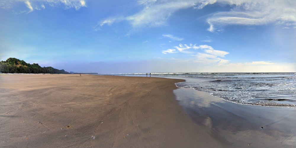 a sandy beach with waves coming in to shore