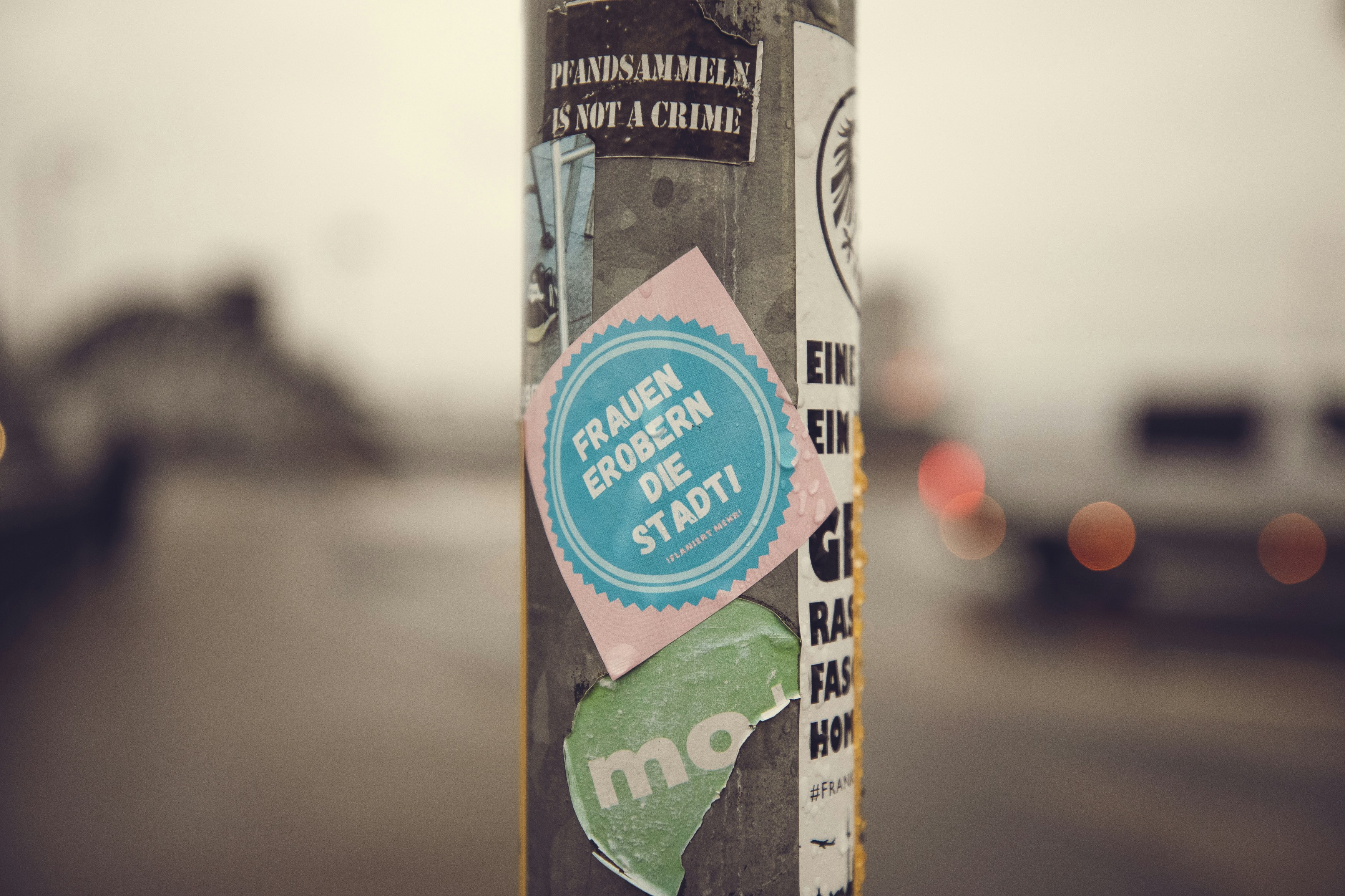a sticker on a pole on a city street, Women take over the city! – Urban protest street art sticker